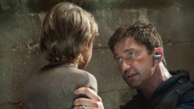 Gerard Butler hjälper ett barn.